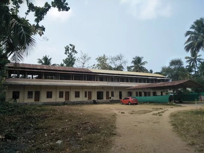 The main two-storey C.S.S. building in open grounds with palm trees