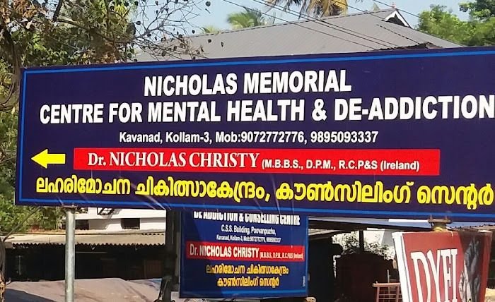 Blue roadside board for Nicholas Memorial Centre with a yellow arrow pointing the way